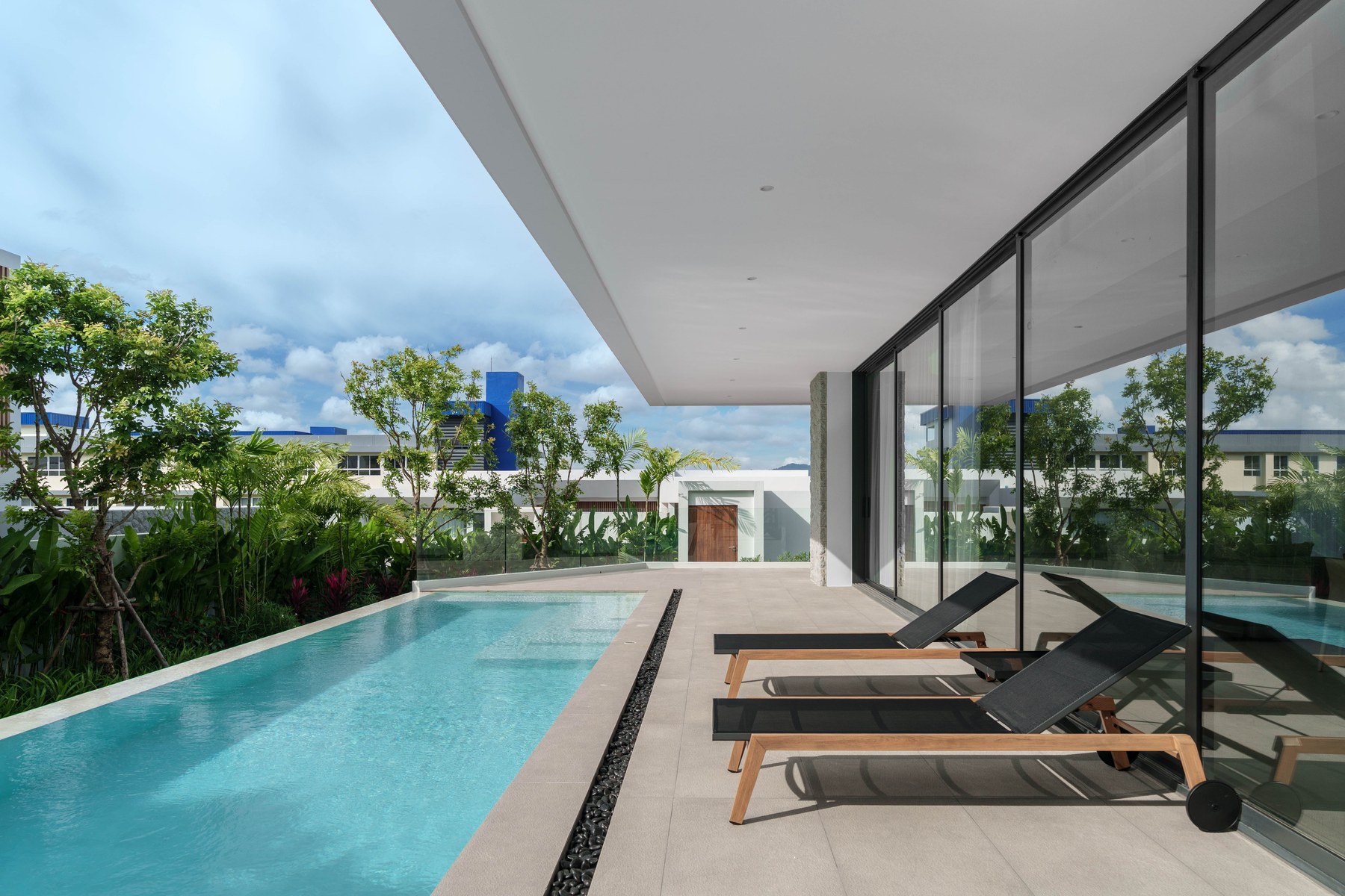 Clover Residence — private pool view through the living room